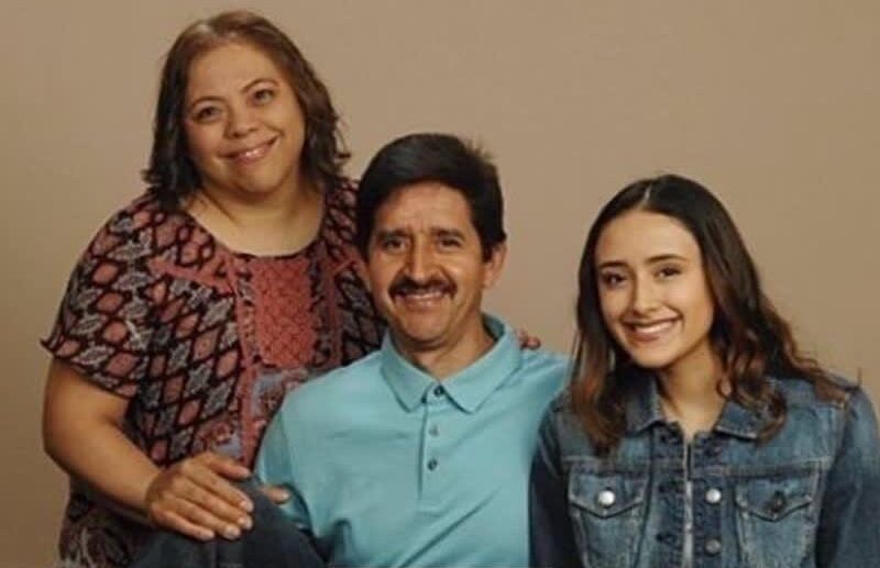 Jose, founder of Nice Color Painting, pictured with his wife and daughter in a family portrait